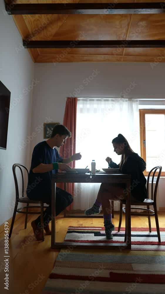 A Quiet Dining Moment Shared Between Two People Sitting at a Table with Delicious Food A Quiet Dining Moment Shared Between Two People Sitting at a Table with Delicious Food