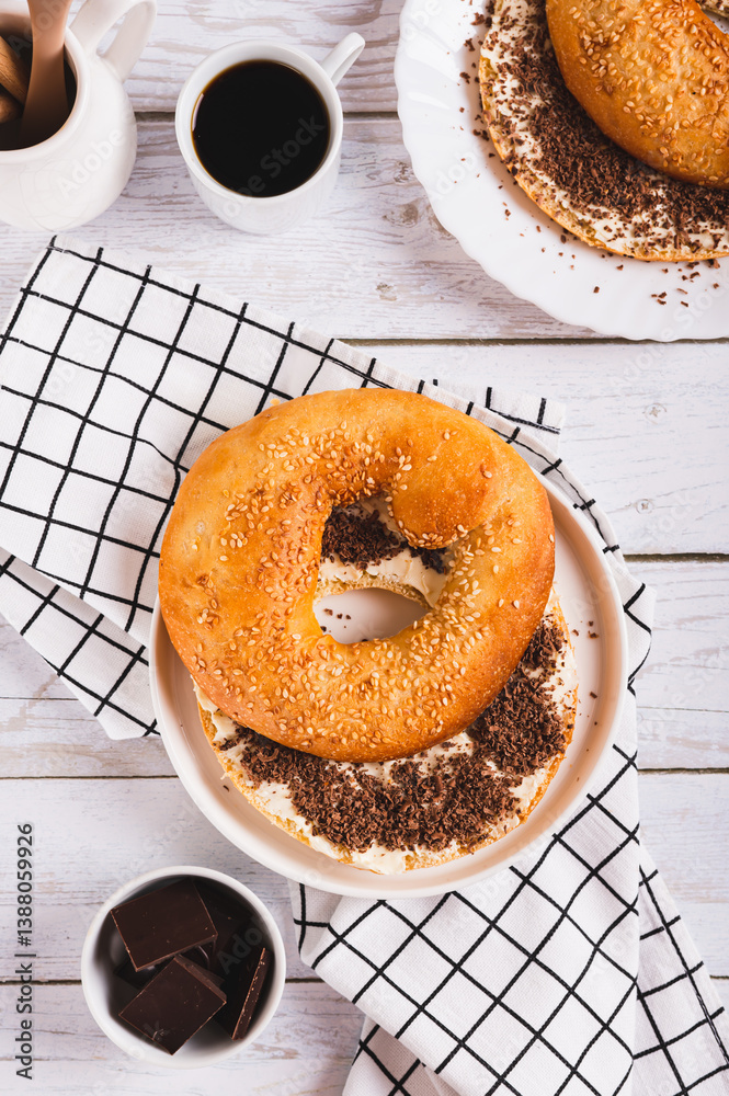 Sweet sandwich with butter, chocolate and sesame seeds on a plate on a table top and vertical view