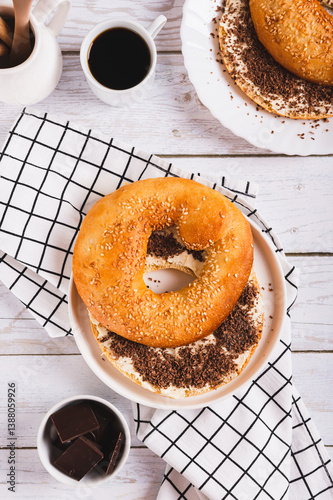 Obraz na płótnie Sweet sandwich with butter, chocolate and sesame seeds on a plate on a table top and vertical view w salonie