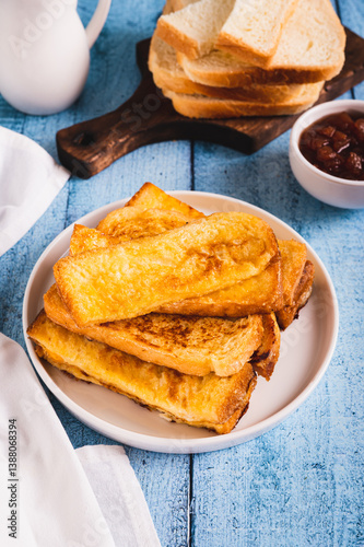 Obraz na płótnie Traditional fried french toasts on white plate on table vertical view w salonie