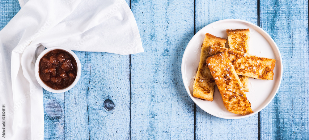 Golden sweet croutons of bread on a plate on the table top view web banner