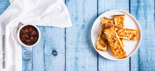 Golden sweet croutons of bread on a plate on the table top view web banner