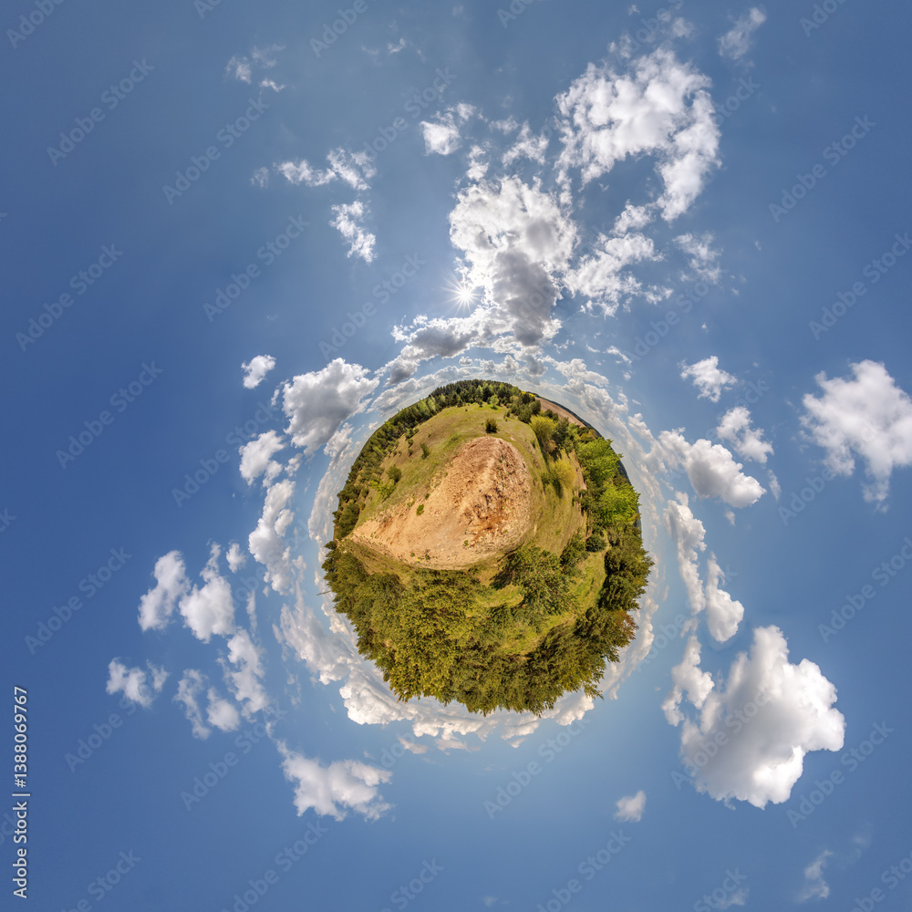simple little tiny planet without buildings in blue sky with sun and beautiful clouds. Transformation of spherical panorama 360 degrees. Spherical abstract aerial view. Curvature of space.