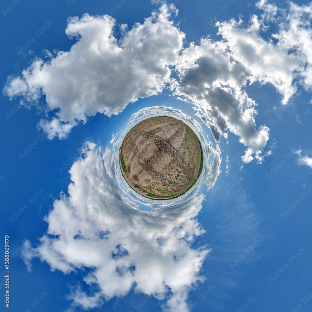 simple little tiny planet without buildings in blue sky with sun and beautiful clouds. Transformation of spherical panorama 360 degrees. Spherical abstract aerial view. Curvature of space.