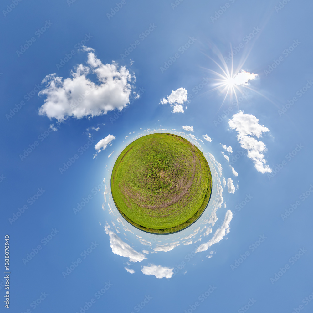 simple little tiny planet without buildings in blue sky with sun and beautiful clouds. Transformation of spherical panorama 360 degrees. Spherical abstract aerial view. Curvature of space.