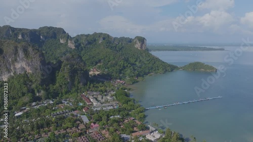 resort surrounded by limestone cliffs on a beautiful beach in Krabi, Thailand.