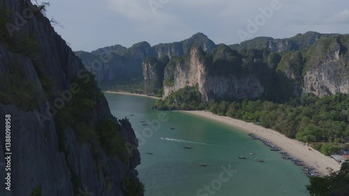 drone shot of a beach with crystal clear blue water and limestone cliffs in Krabi, Thailand. Railay Beach.