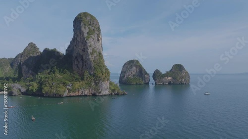 drone shot of a beach with crystal clear blue water and limestone cliffs in Krabi, Thailand. Railay Beach.