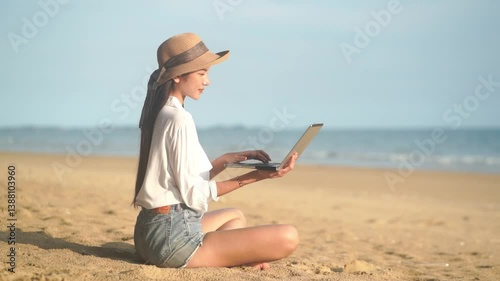 Young freelance women working with her laptop on holiday at the beach .