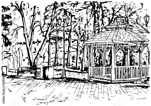 Wooden gazebo in the park against the background of trees