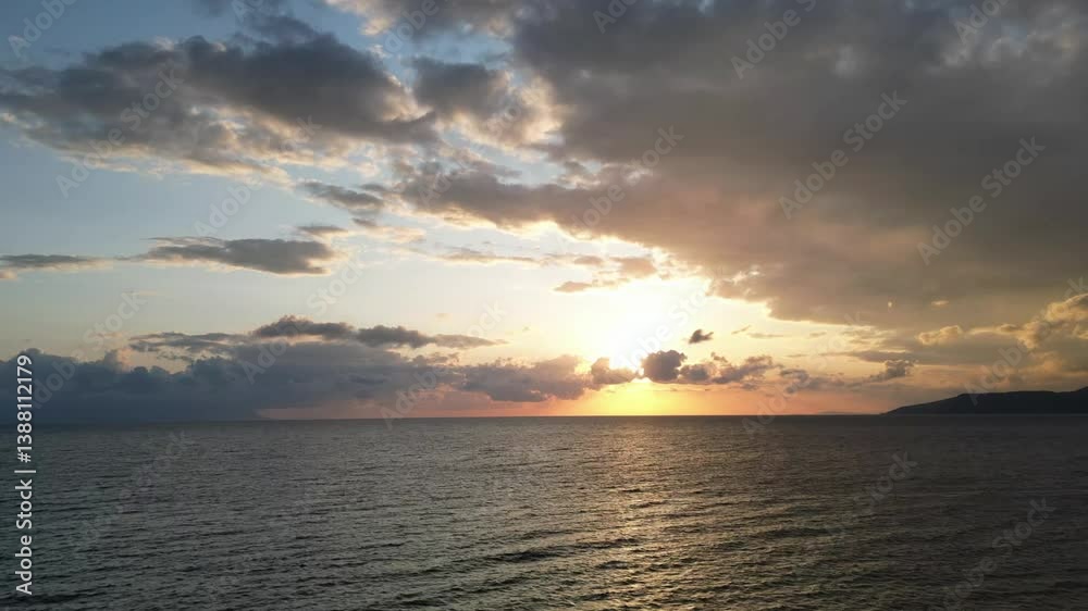Sunset at sea aerial drone timelapse flow of clouds and sea waves