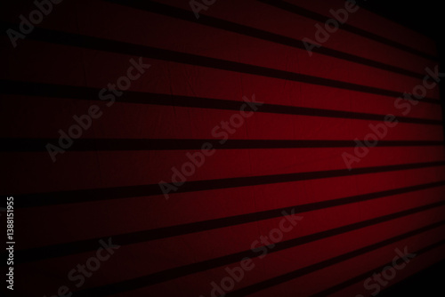 Red textured wall with horizontal lines illuminated in soft light during an evening setting