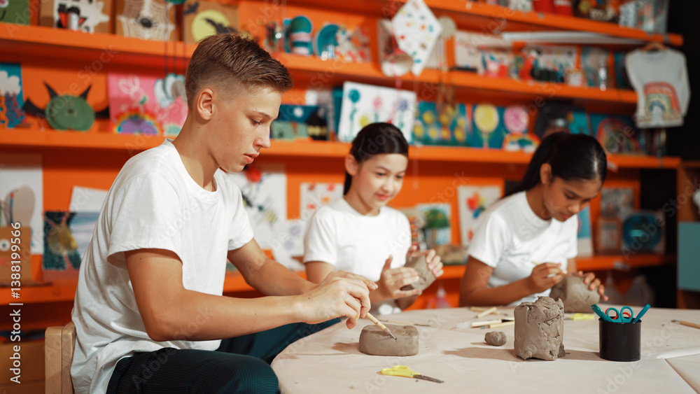 Group of happy smart diverse student working with clay art at pottery workshop. Multicultural attractive highschool student modeling, smash, playing clay. Creativity activity concept. Edification. Group of happy smart diverse student working with clay art at pottery workshop. Multicultural attractive highschool student modeling, smash, playing clay. Creativity activity concept. Edification.