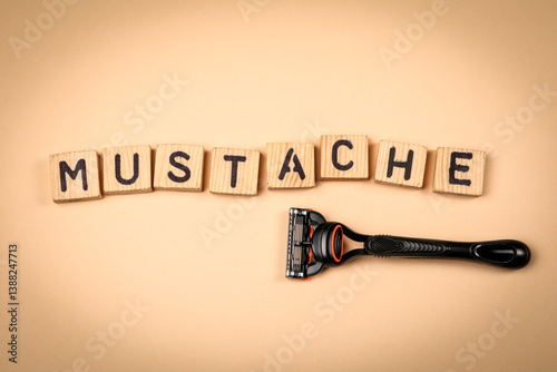 MUSTACHE. Word from wooden alphabet blocks on a light background