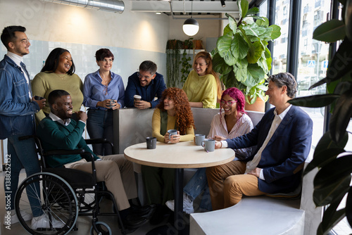 Multiracial and multigenerational colleagues enjoying coffee break in coworking space
