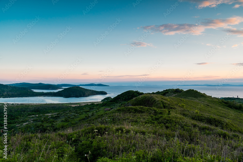 Green hills during sunset. Path among picturesque views of hills near the sea. Green hills during sunset. Path among picturesque views of hills near the sea.