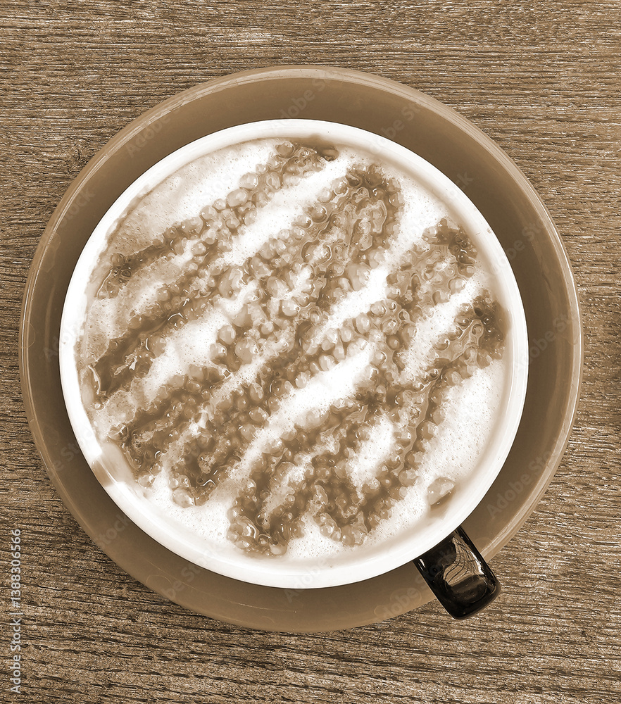 Cappuccino in red cup on wooden table