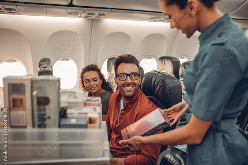 A friendly flight attendant joyfully engages with smiling passengers during inflight service and refreshments