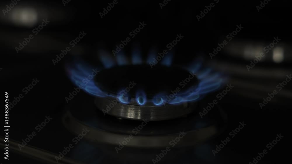Gas burner with blue flame on stove, closeup Gas burner with blue flame on stove, closeup