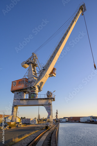 cranes in the port at sunset
