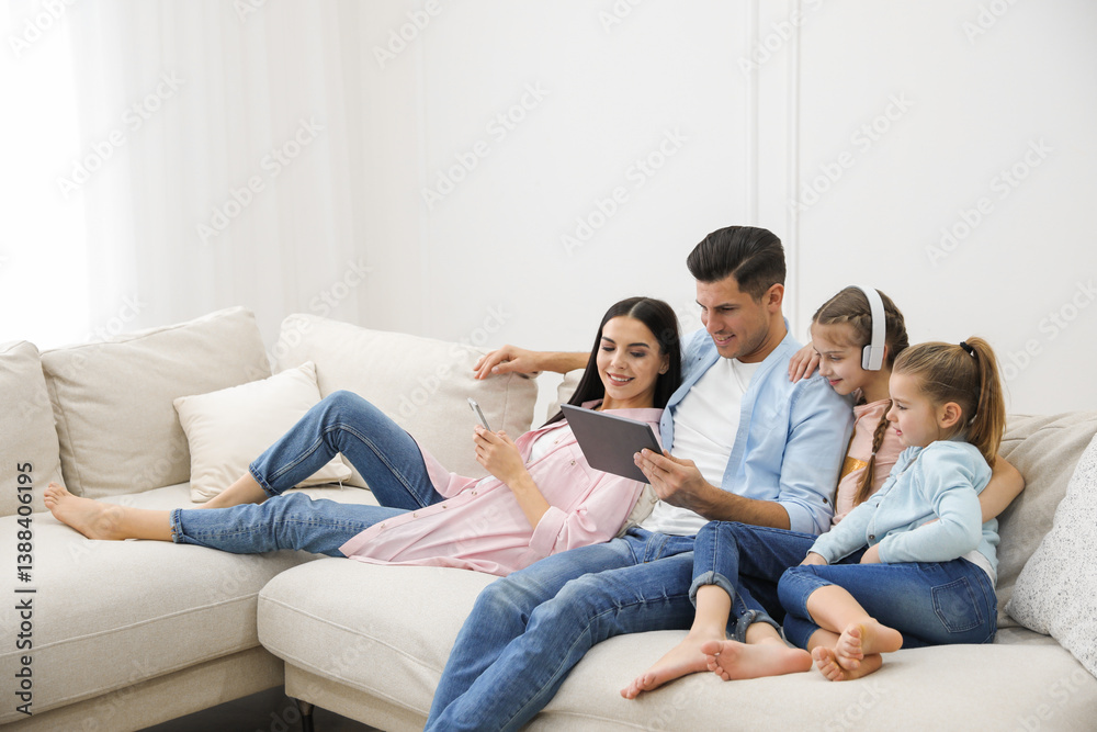 Family with tablet on comfortable sofa in living room Family with tablet on comfortable sofa in living room
