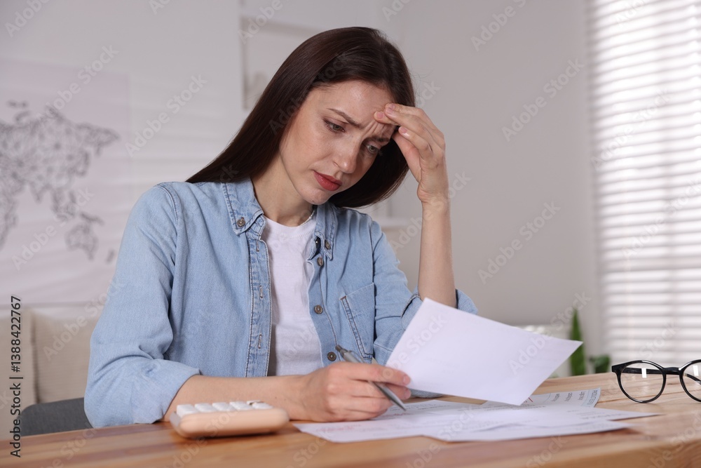 Paying bills. Woman with calculator and invoices at wooden table indoors Paying bills. Woman with calculator and invoices at wooden table indoors