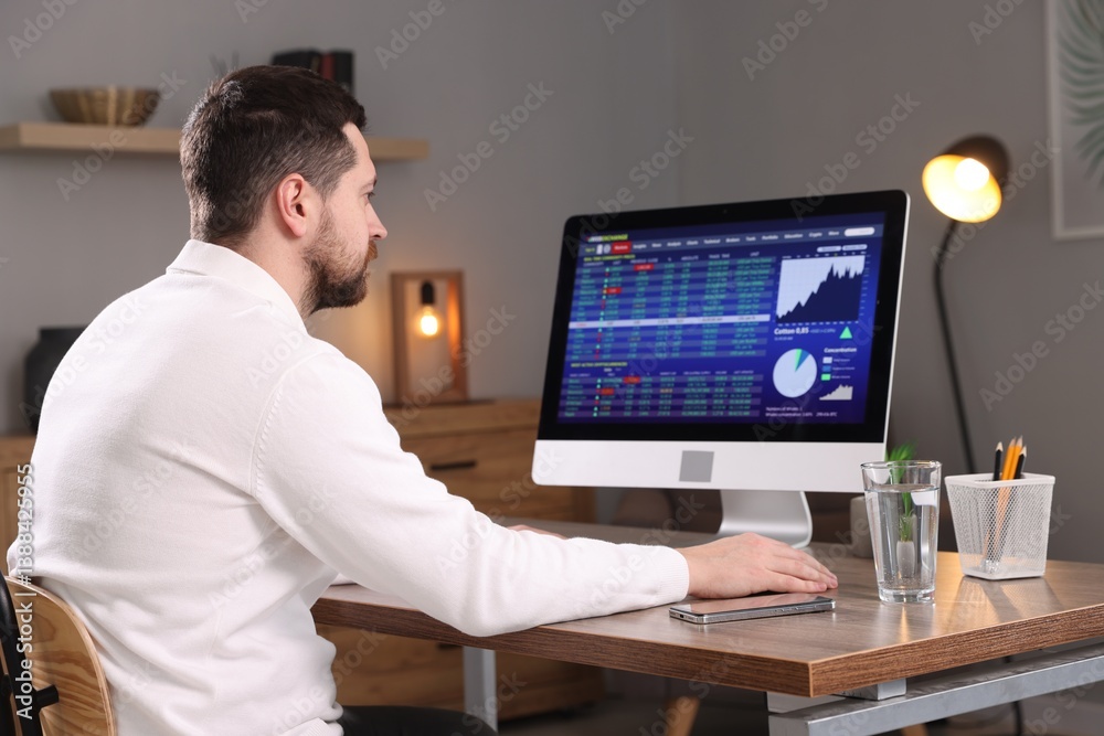 Stock exchange. Man analysing financial market on computer at desk indoors Stock exchange. Man analysing financial market on computer at desk indoors