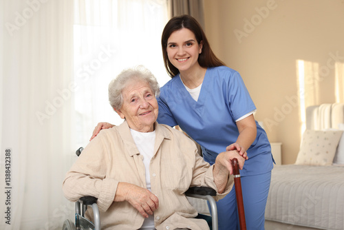 Obraz na płótnie Healthcare worker with elderly woman in wheelchair indoors w salonie