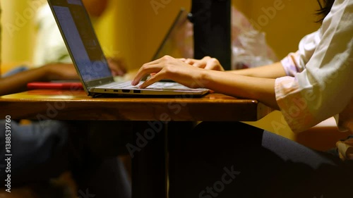 Asian hand woman using digital tablet and laptop computer, working at cafe coffee shop. Female student studying online via tablet and laptop computer, reading e-book mobile app, internet technology