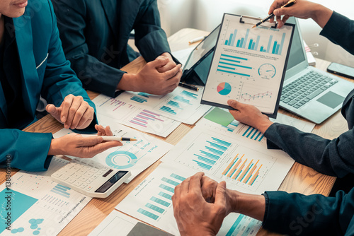 Fotografie Paperwork and hands on table in business presentation or seminar Group of confident businessmen pointing at graphs and charts to analyze market data, balance sheet, accounting, net profit