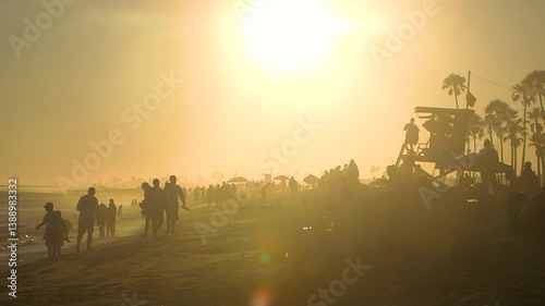 Silhouettes on the beach at sunset, golden hour