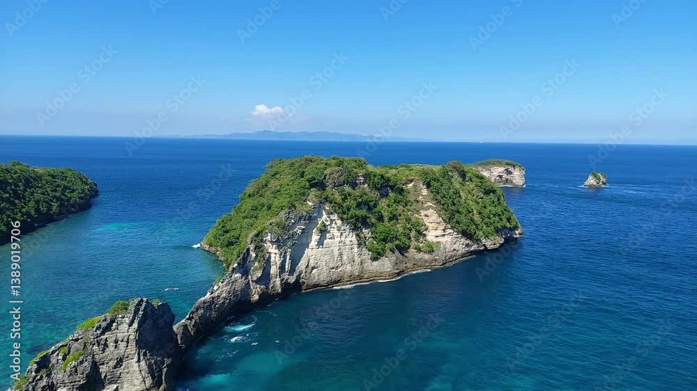 Tranquil Cove Surrounded by Lush Green Cliffs and Azure Waters in Nusa Penida Tranquil Cove Surrounded by Lush Green Cliffs and Azure Waters in Nusa Penida