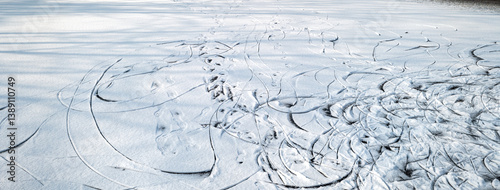 Obraz na płótnie Frozen lake covered in snow. Skate tracks in the snow. w salonie