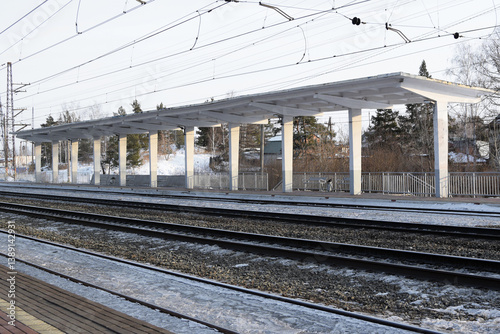 Empty railway tracks and empty passenger platform. Railway station.