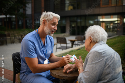 Doctor explaining medication to senior patient and answering her questions.