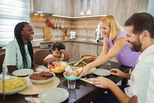 Friends enjoying a vibrant dinner at a cozy kitchen table