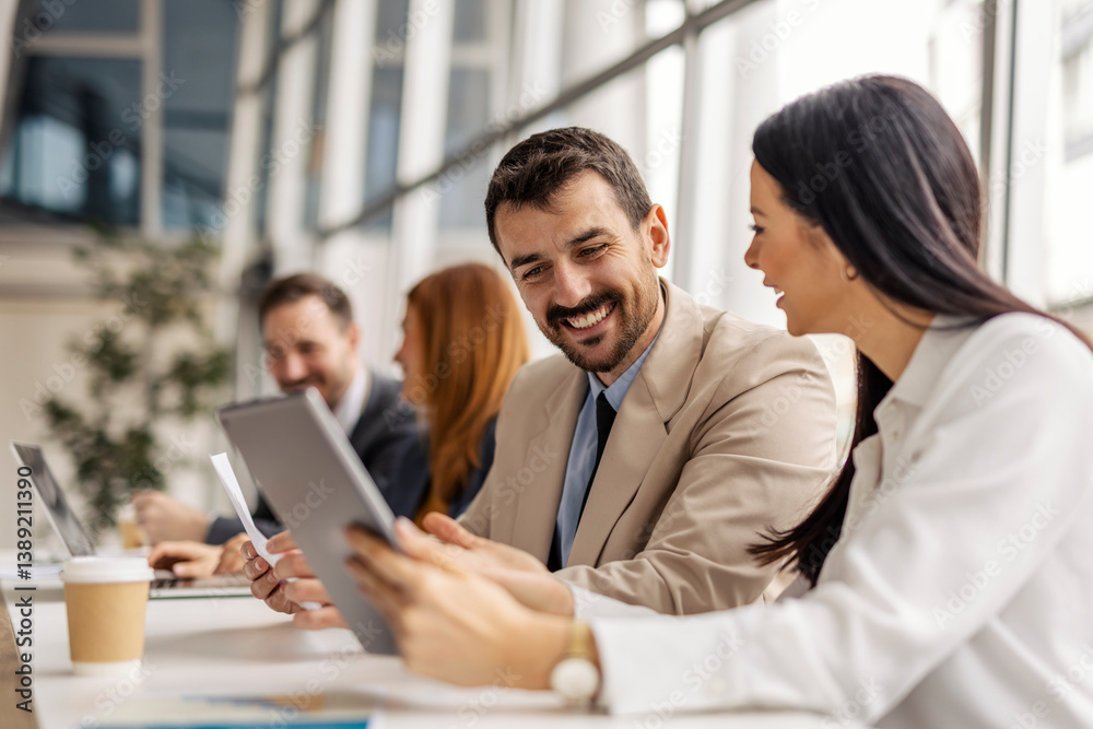 Data analysts sitting at boardroom with tablet and paperwork in hands and doing case study. Data analysts sitting at boardroom with tablet and paperwork in hands and doing case study.