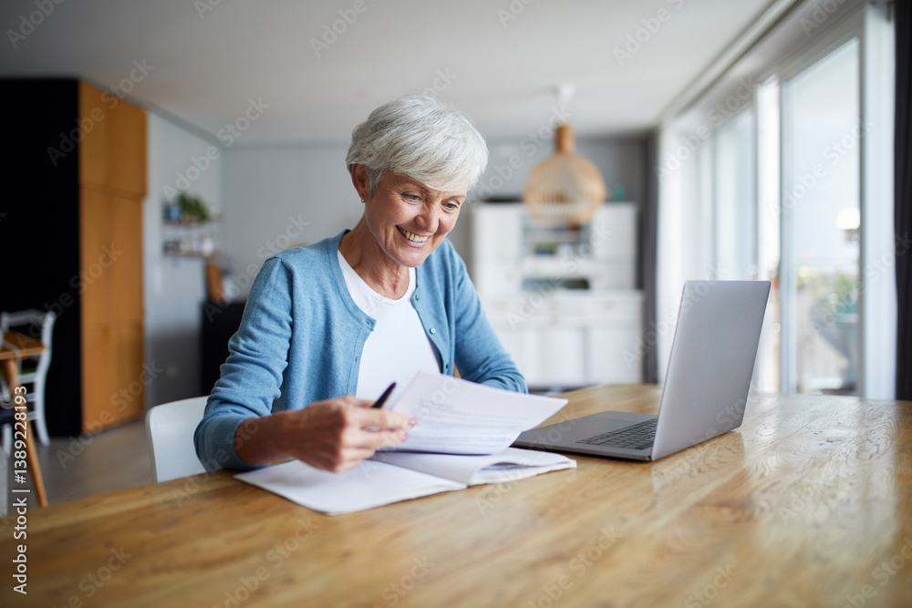 Woman working on a laptop at home in a bright kitchen Woman working on a laptop at home in a bright kitchen