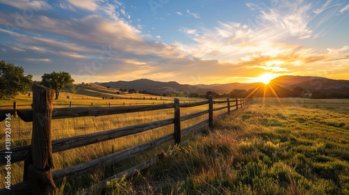 Picturesque sunrise over a fenced ranch with rolling hills and vibrant sky