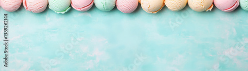 Colorful ice cream scoops arranged on light blue background create delightful and refreshing scene