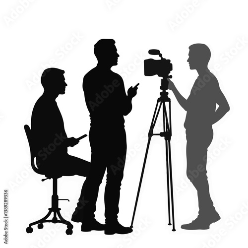 Workers collaborating during a video shoot in silhouette  