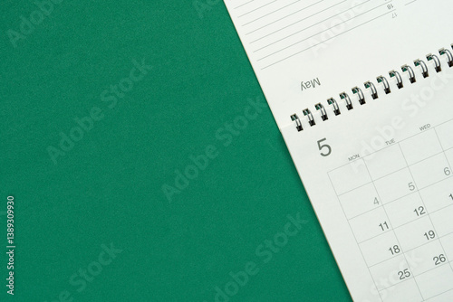 close up of calendar on the green table background, planning for business meeting or travel planning concept