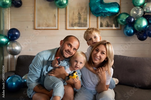 Obraz na płótnie Family celebrates a special occasion at home with balloons and joyful expressions during a cozy afternoon w salonie