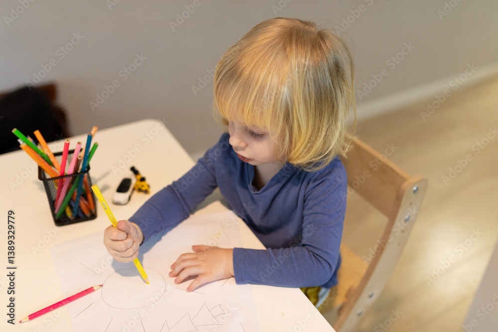 Child practicing drawing in a cozy indoor space during afternoon hours