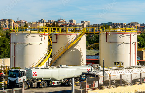 oil petroleum storage for refuel air planes of aircraft of a city airport with car refuelers with jet A-1 fuel at the airport, fuel terminal and filling station photo