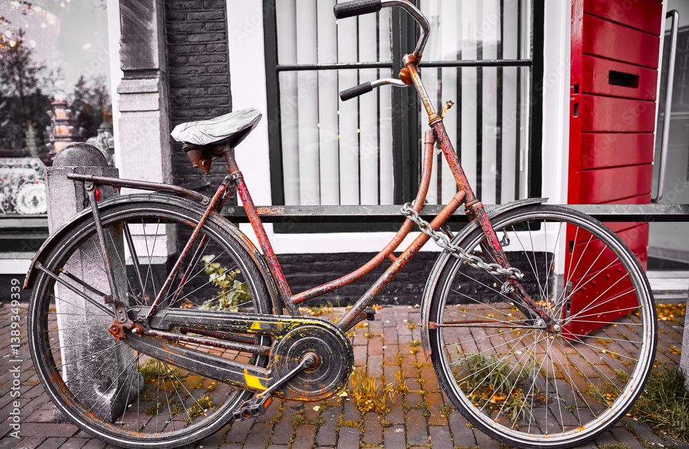Amsterdam, Netherlands. Old retro bicycle parked on the street. Vintage aged transport for healthy lifestyle.