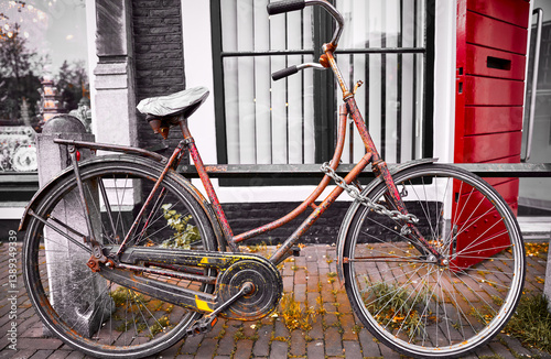 Obraz na płótnie Amsterdam, Netherlands. Old retro bicycle parked on the street. Vintage aged transport for healthy lifestyle. w salonie