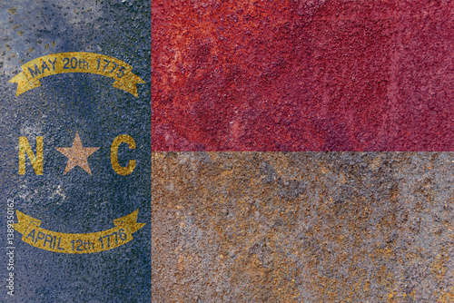 North Carolina State Flag. Dirty North Carolina state flag on rusty metal surface.