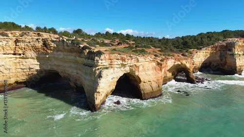 Drone footage showing Algarve cliffs and turquoise ocean with boat