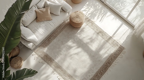 Bright living room with white couch, rug, and plant.